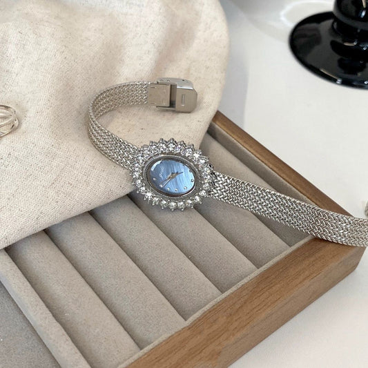 Retro-style oval dial gold/silver strap zircon watch