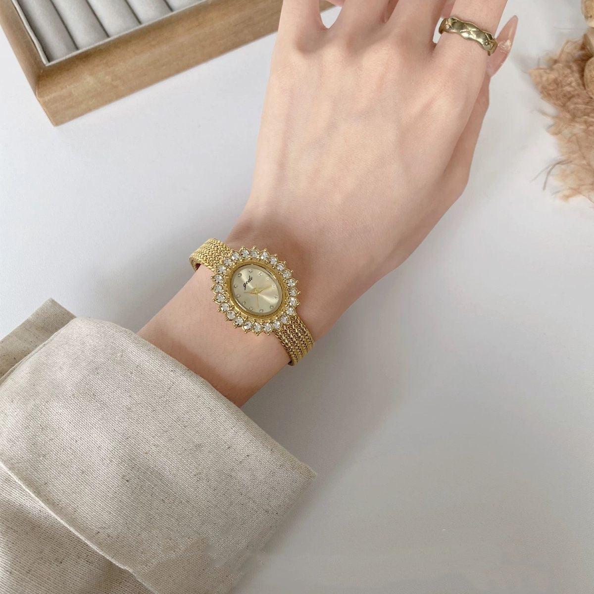 Retro-style oval dial gold/silver strap zircon watch