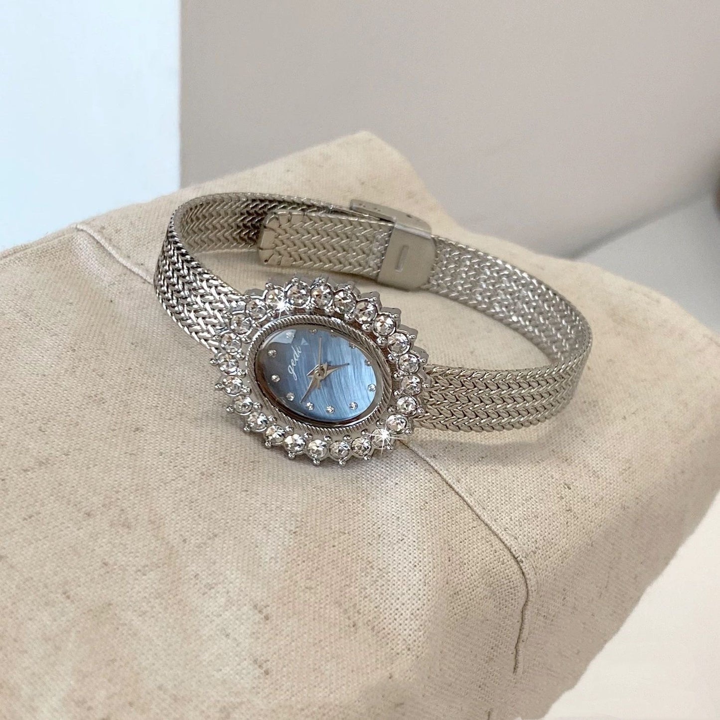 Retro-style oval dial gold/silver strap zircon watch