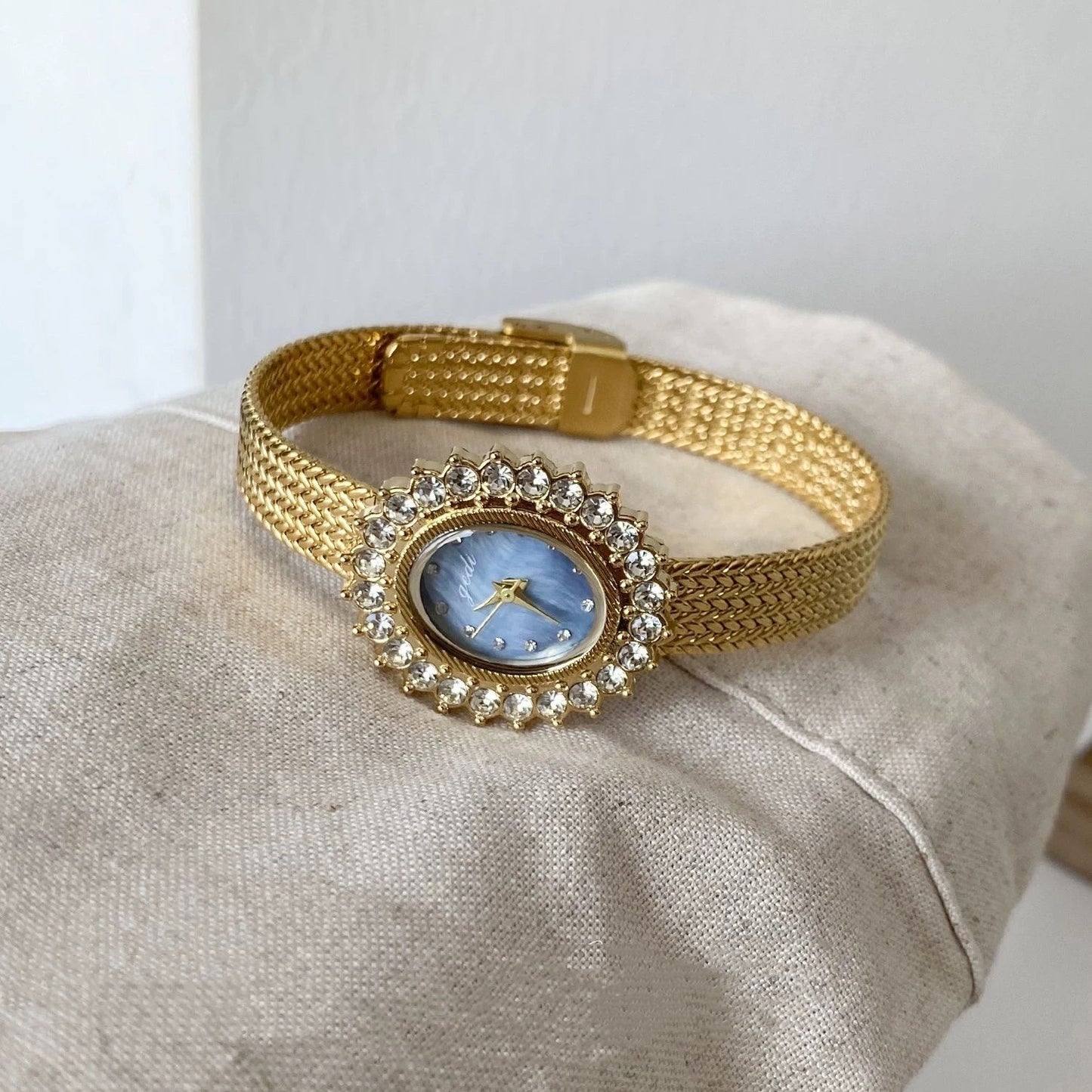 Retro-style oval dial gold/silver strap zircon watch