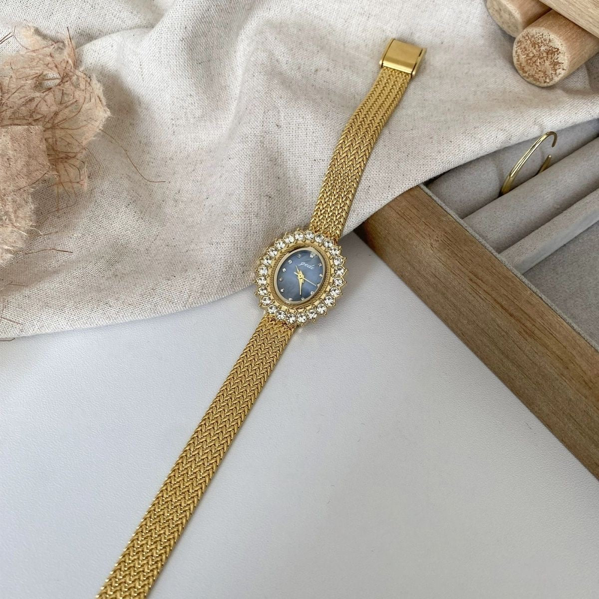 Retro-style oval dial gold/silver strap zircon watch